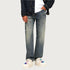 Wide leg vintage wash jeans styled with denim jacket and white platform sneakers with colorful accents