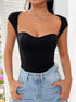 Close-up front: Black sweetheart neckline bodysuit with cap sleeves, fitted design, and silver heart pendant necklace.
