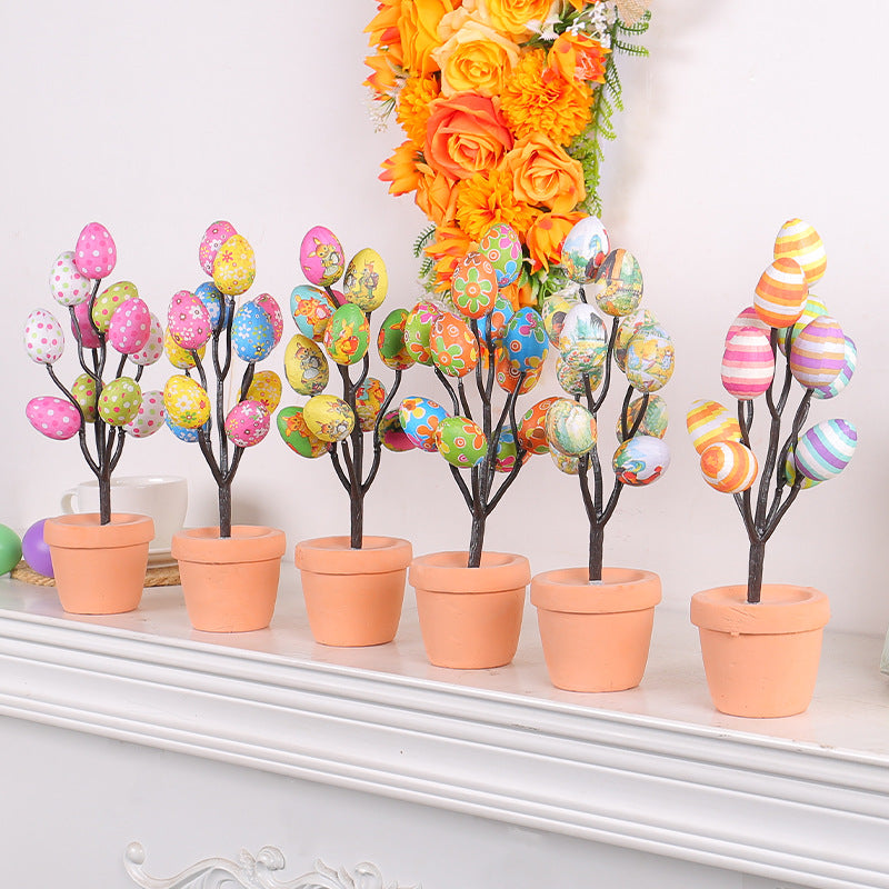 Easter egg tree decorations on a white mantel featuring vibrant painted eggs in terracotta pots, adding a festive touch.
