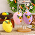 Three Easter egg decorations in pink, purple, and yellow hanging from a white tree stand, each measuring 13cm x 10cm.