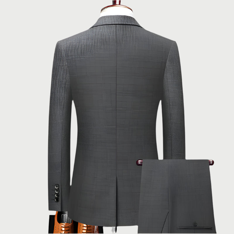 Back view of tailored gray suit jacket on mannequin showing clean lines and center vent with matching trouser sample