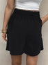 Soft black elastic-waist shorts with white crop top, showcasing comfortable summer casual wear