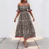 Front view of a woman wearing an off-shoulder leopard print maxi dress with short ruffled sleeves and red trim.