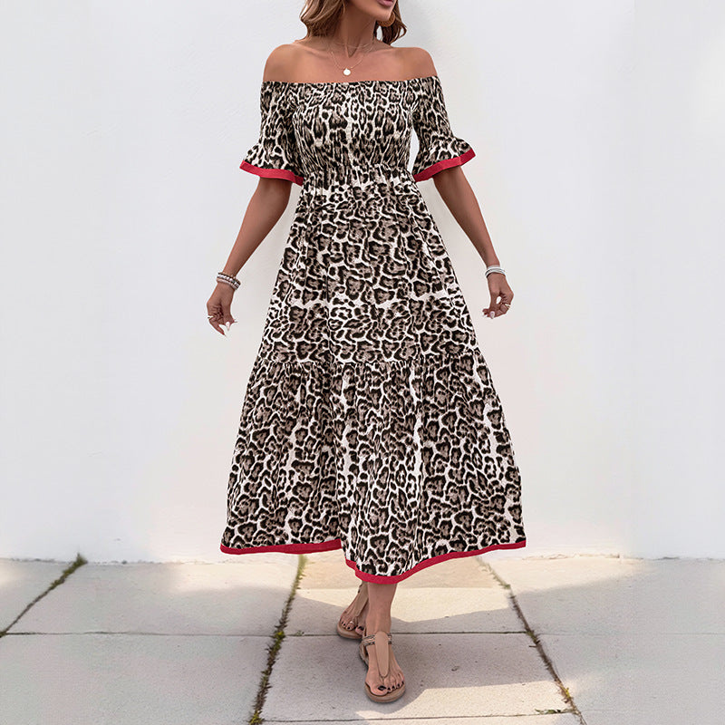 Front view of a woman wearing an off-shoulder leopard print maxi dress with short ruffled sleeves and red trim.