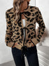 Model wearing leopard print knit cardigan with black ties, styled with white undershirt and dark pants