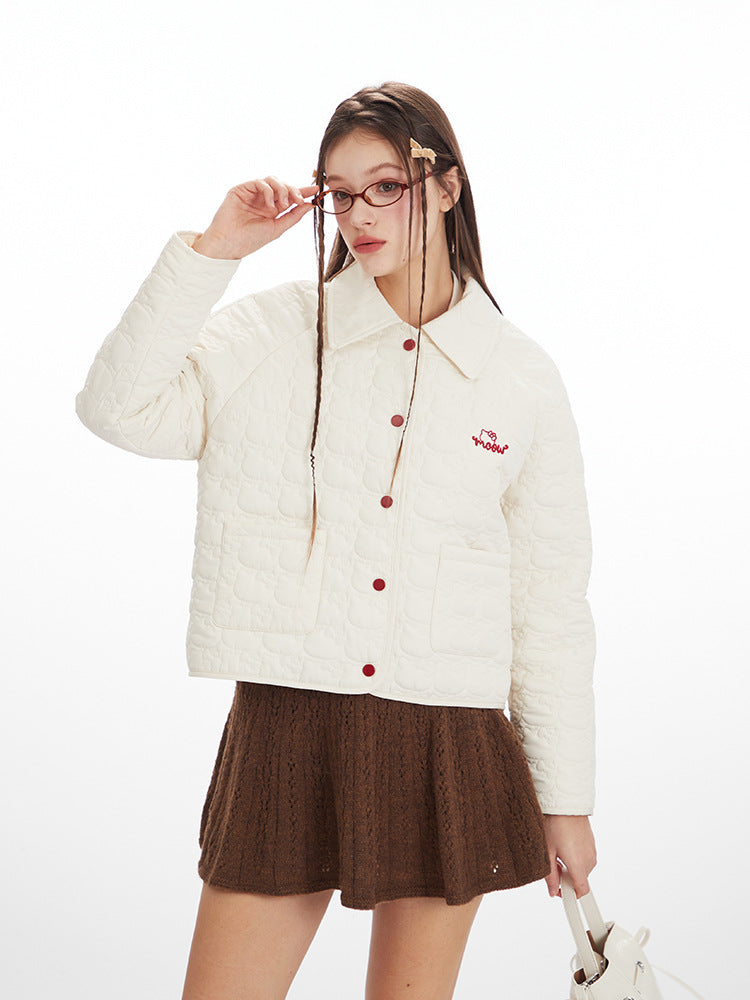Woman wearing a white jacket with red buttons and a brown skirt on a white background