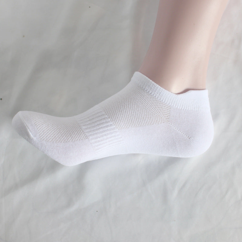 Side view of white athletic ankle sock on mannequin foot showing contoured fit
