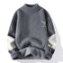 Gray mockneck sweater with striped sleeves and deer logo