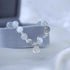 Close-up of moonstone and silver bracelet with crystal charm on grey display
