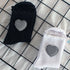 Black and white crew socks with ruffle trim and gingham heart patches, showing detailed pattern