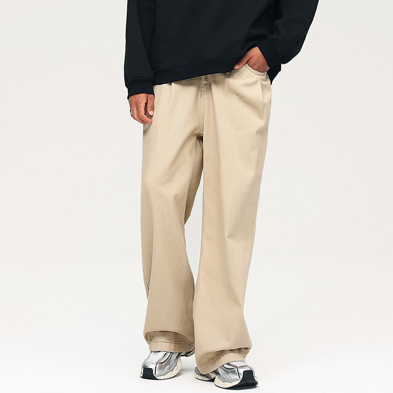 Beige wide-leg trousers with black hoodie and silver sneakers, showing front view