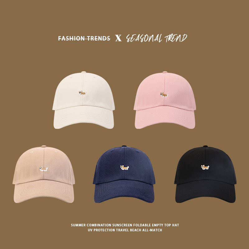 Five baseball caps with corgi embroidery in different colors: white, pink, beige, navy, and black