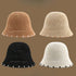 A set of four straw bucket hats in khaki, beige, white, and black, each with subtle contrast trim for a stylish summer look.