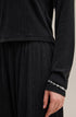 Cuff close-up of black long sleeve tee with fine stitching