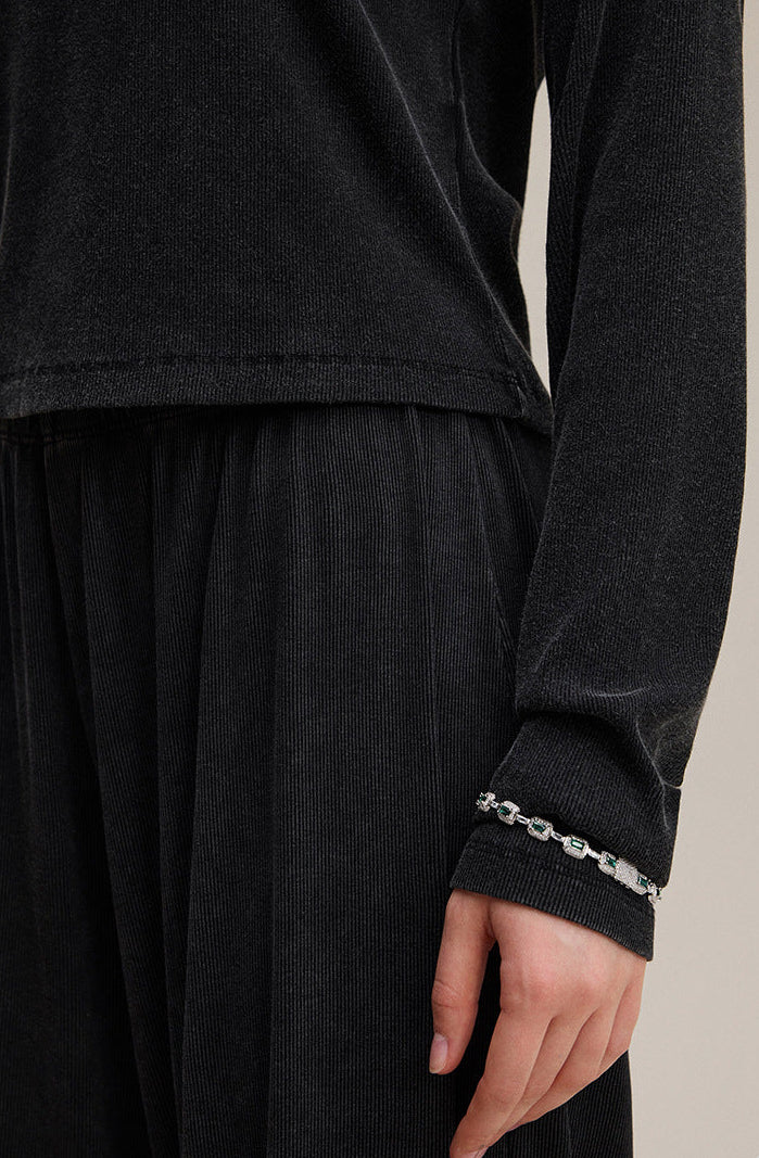 Cuff close-up of black long sleeve tee with fine stitching