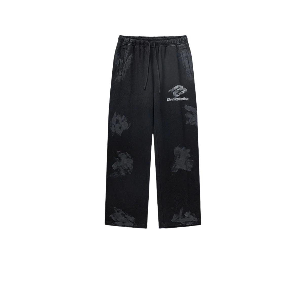 Black Backstairs sweatpants with wide-leg fit, elastic waistband with drawstring ties, distressed paint-effect pattern, and silver logo print