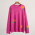 Berry oversized sweater with yellow rose and green leaf pattern, studio product shot