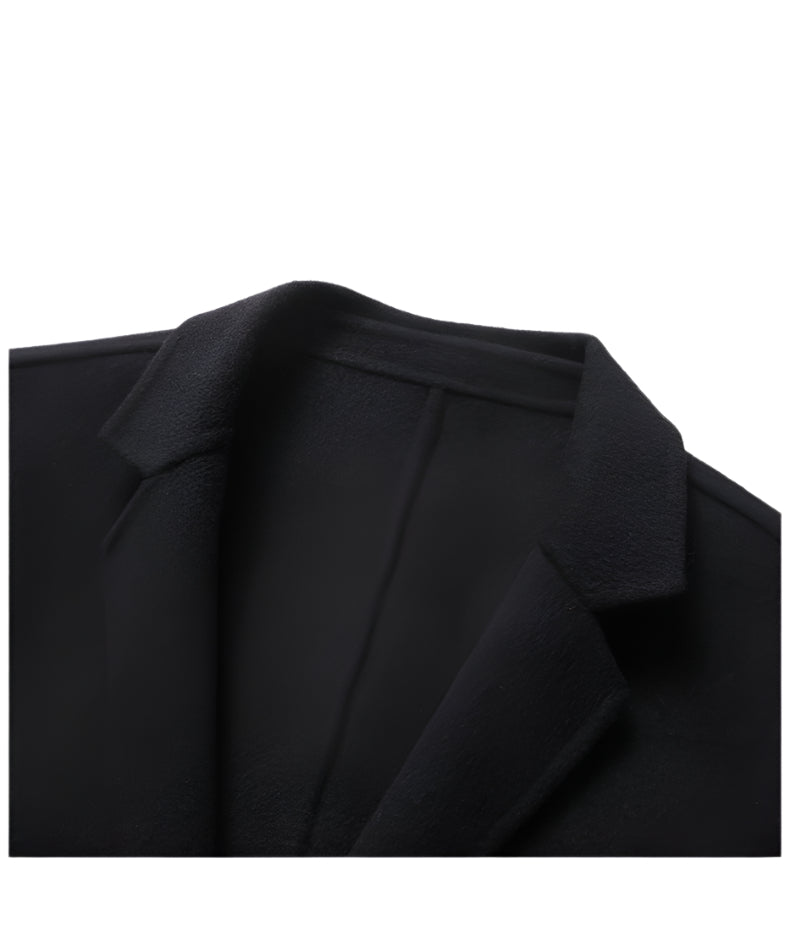 Close-up of black wool blazer lapel showing fine texture and stitching detail