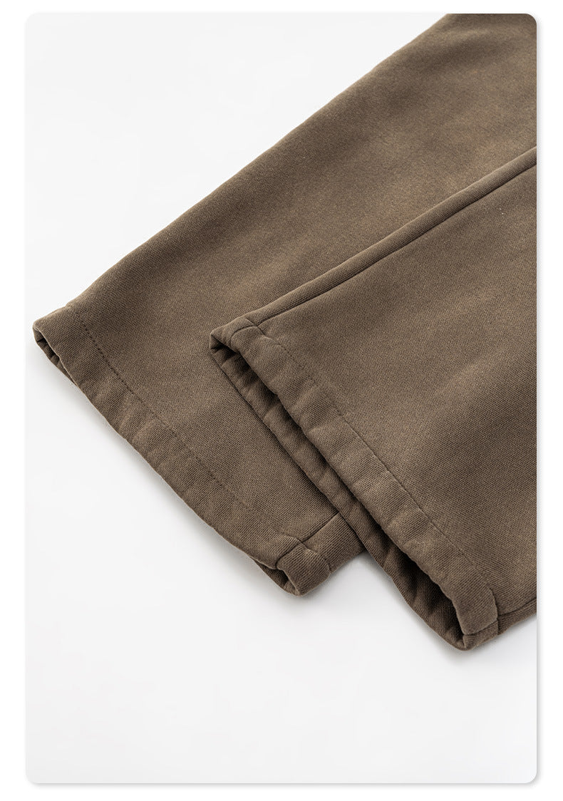 Detail of taupe sweatpants hem with rolled cuff stitching at ankle