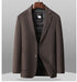 Dark brown wool blazer with open front displaying black quilted down lining and DOWN FILLER sheep logo tag