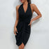 Side view of black wrap halter dress showing ruched waist detail and asymmetric hem