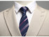Close-up of navy striped tie with pink accents against beige suit lapel
