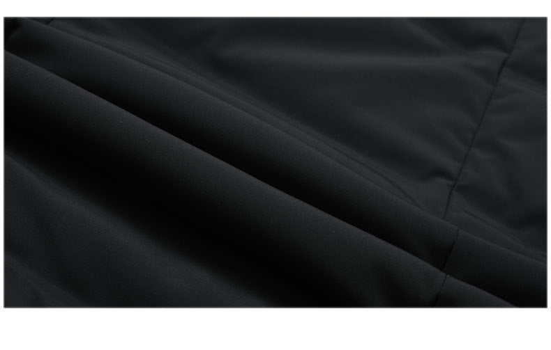 Close-up of black fabric texture showing smooth surface quality of the down coat