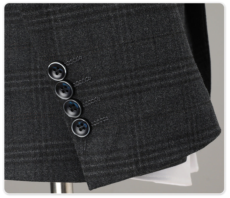 Close-up of sleeve cuffs with four button detail on charcoal plaid suit jacket