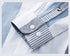 Premium shirt cuff detail showing contrast striped fabric lining and quality button placement