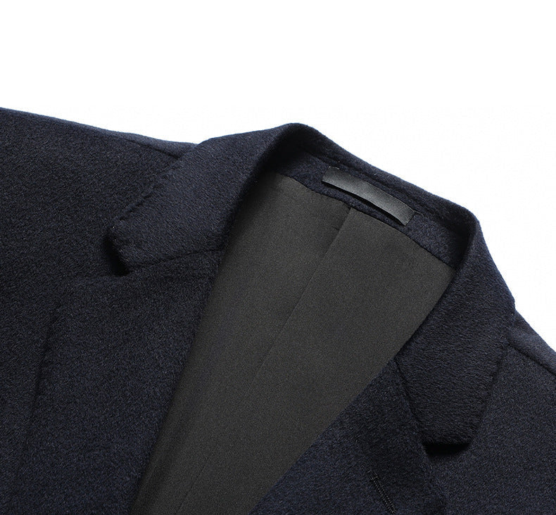 Close-up of navy blazer lapel and collar construction showing detailed interior lining