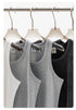 Set of four ribbed tank tops in white, gray, and black on clear plastic hangers