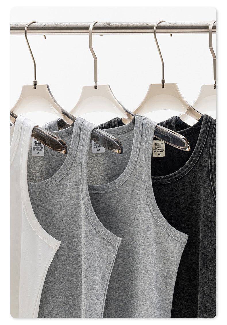 Set of four ribbed tank tops in white, gray, and black on clear plastic hangers