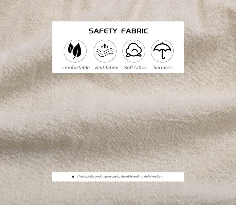 Close-up of eco-friendly cream fabric with safety certification icons showing comfortable, breathable, soft and harmless textile properties