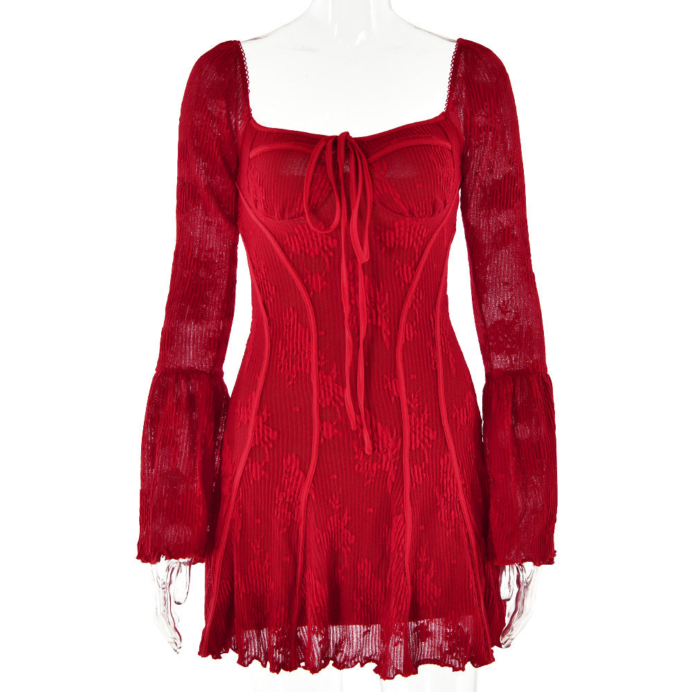 Red lace mini dress with structured bodice, tie front, and bell sleeves displayed on a mannequin against white background
