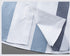 Shirt hem detail showing side vent construction and quality finishing on plaid pattern