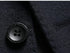 Close-up of black wool blazer fabric showing texturized surface and fine tailoring details