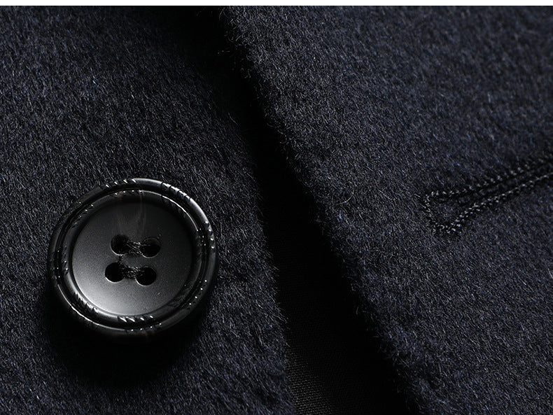 Close-up of black wool blazer fabric showing texturized surface and fine tailoring details