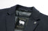 Close-up detail of navy wool blazer lapel showing DOWN FILLER black label with white sheep logo and gold text