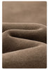 Extreme close-up of taupe cotton sweatpants fabric showing knit texture and subtle color variations