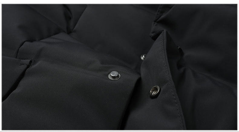 Detail of metal snap closure system on quilted coat front with reinforced buttonhole