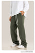 Side view of person in white shirt and olive green sweatpants showing pocket detail and relaxed fit
