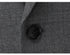 Detail shot of black suit button on gray wool fabric showing texture and stitching of high-quality suiting material