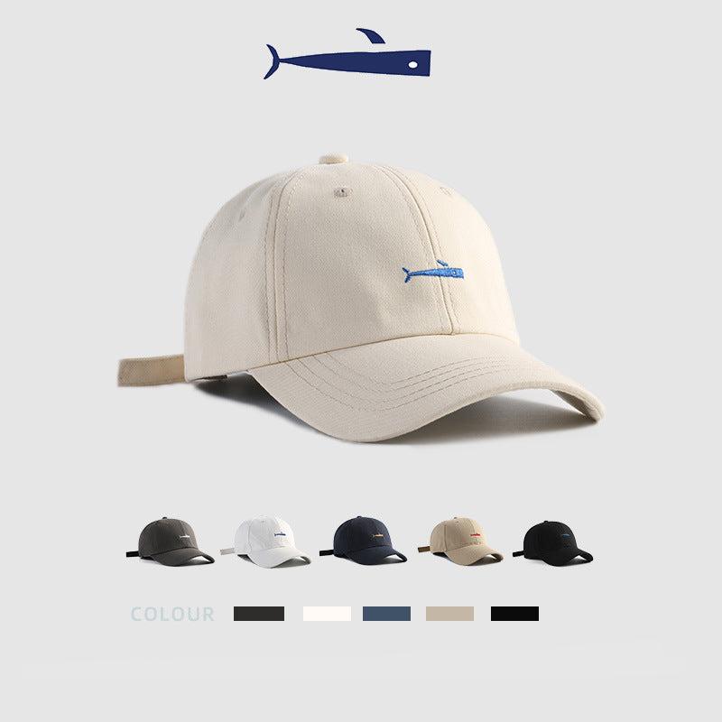Beige baseball cap with blue embroidered fish logo and adjustable strap