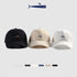 Set of three baseball caps in black, beige, and white, with embroidered fish logos
