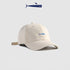 White baseball cap with a blue embroidered fish logo, clean and modern design