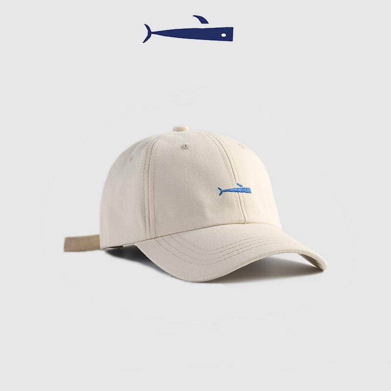 White baseball cap with a blue embroidered fish logo, clean and modern design
