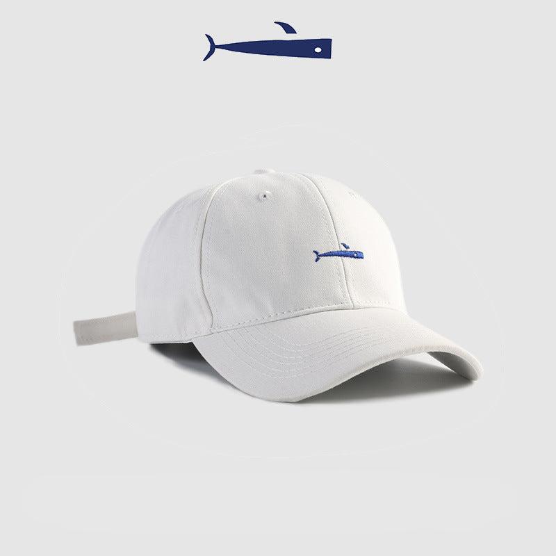White baseball cap with a blue embroidered fish logo, clean and modern design