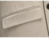 Close-up of beige suit jacket pocket with precise tailoring details