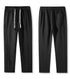 Close-up details of drawstring and waistband on black pants