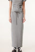 Light gray long denim skirt and matching short-sleeve top with gray and black sneakers with white bow laces